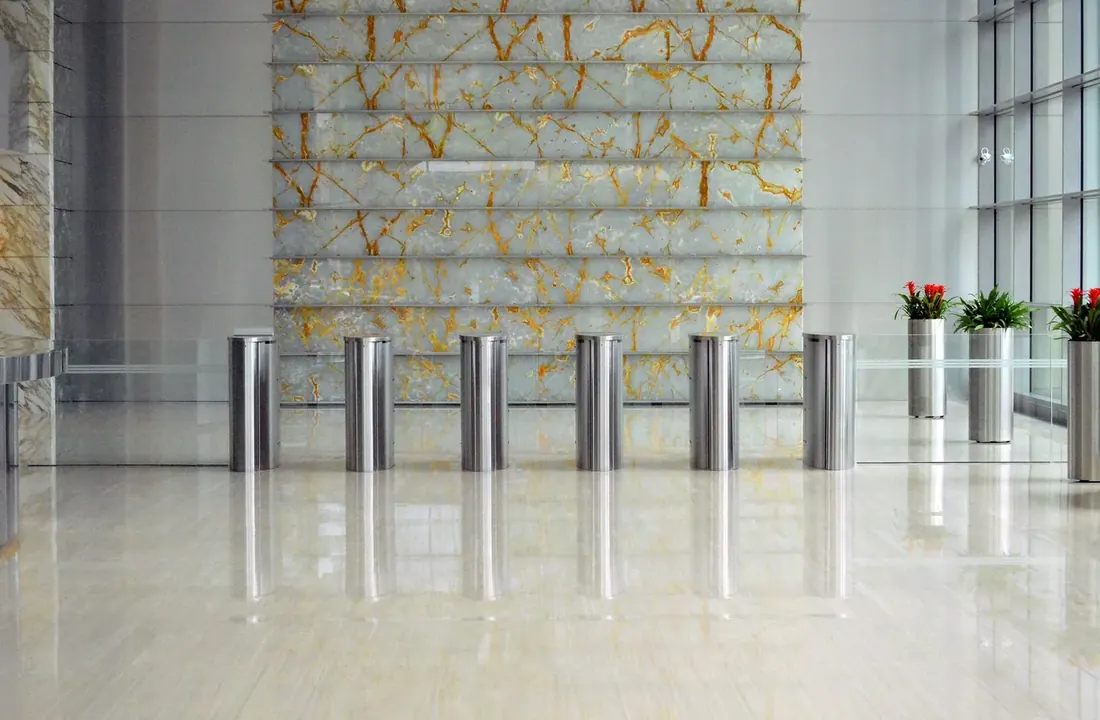 Polished stone lobby with entry gates and a stone feature wall