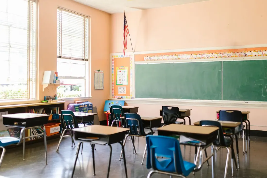 Sunlit classroom with desks arranged before the school day