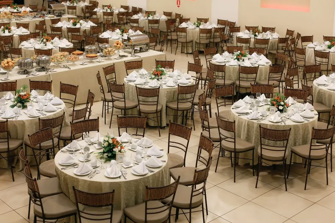 Banquet room of round tables set with glassware for an event
